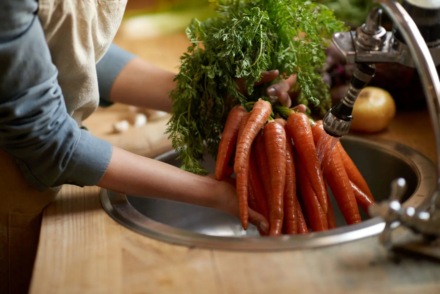 Washing carrots in the sink 